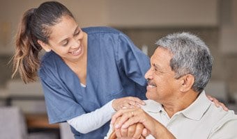 Nurse speaking with an elderly male patient