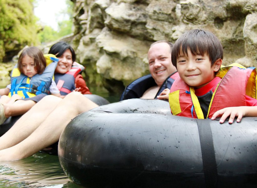 Family on inner tubes floating in the water