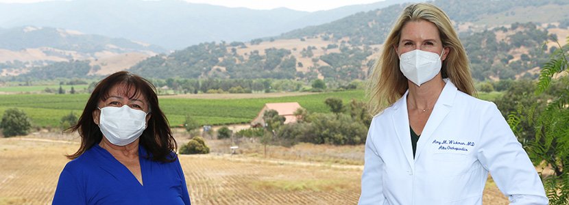 Luciana Gallegos and Amy Wickman, MD standing outdoors with masks on. 