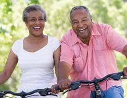 A couple standing over their bikes together