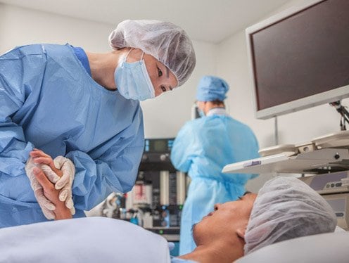 Clinician smiling at a patient after surgery