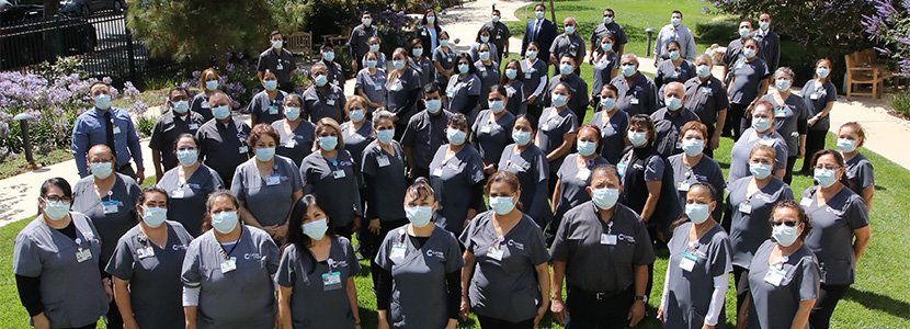 A large group photo of masked Cottage Health staff members.