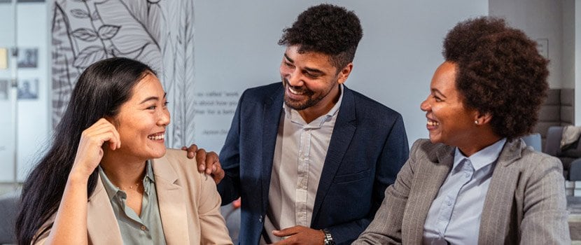 Group of professionals sitting at a table and smiling