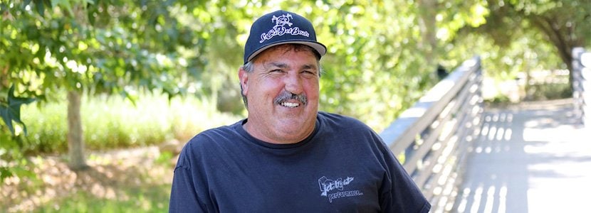 Kevin Vieweg smiling on a bridge.